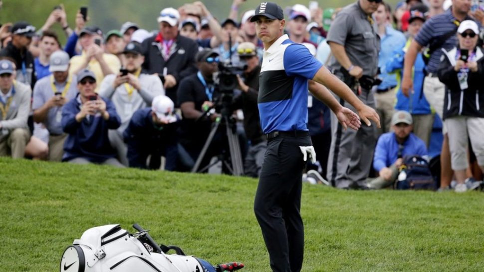 Brooks Koepka prepares to putt on the 18th green (Seth Wenig/AP)