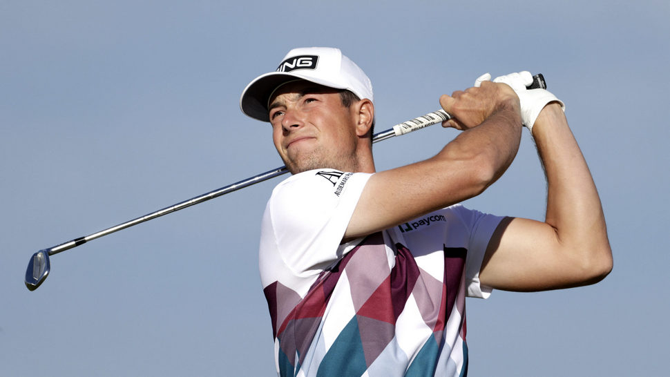 Viktor Hovland watches his iron shot 