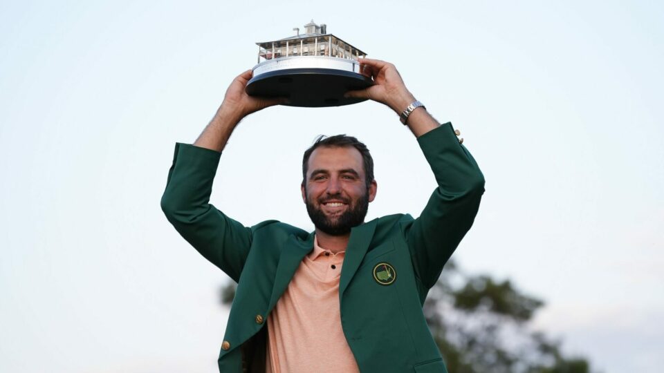 Scottie Scheffler holds the trophy after winning the Masters golf tournament