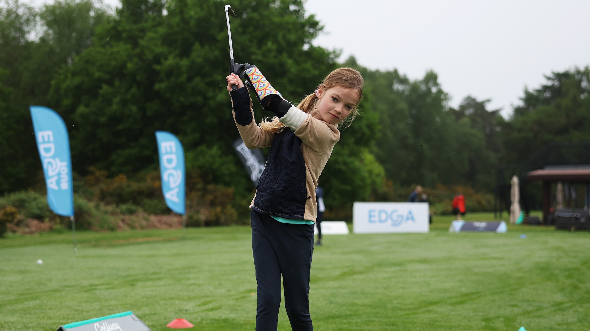 Joanie hitting the ball with her Koalaa prosthetic