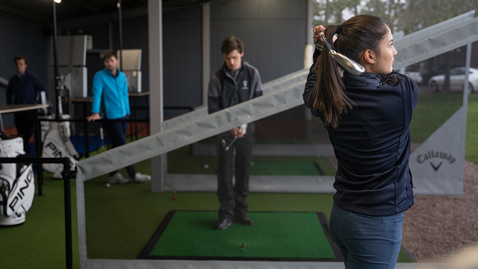 PGA students on a driving range 