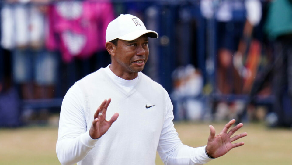 Tiger Woods raises his hands at the 2022 Open