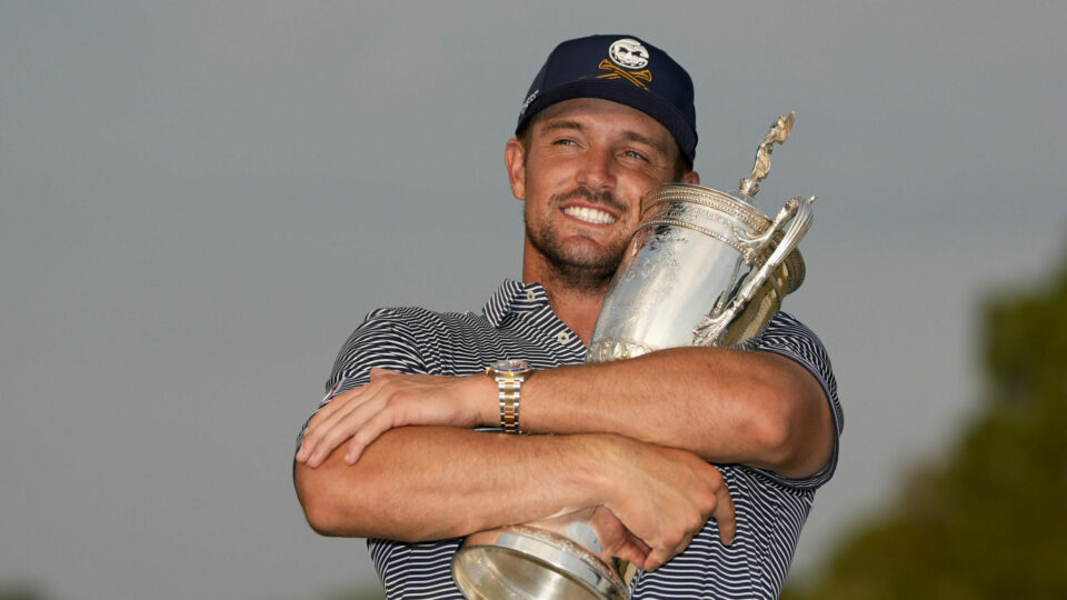 Bryson DeChambeau cradles the US Open trophy