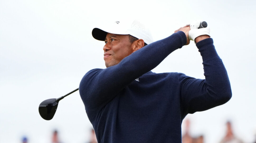 Tiger Woods watches his second shot on the fourth hole