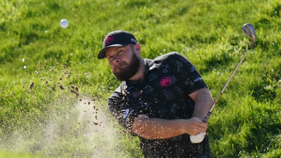 Tyrrell Hatton splashes out of a bunker
