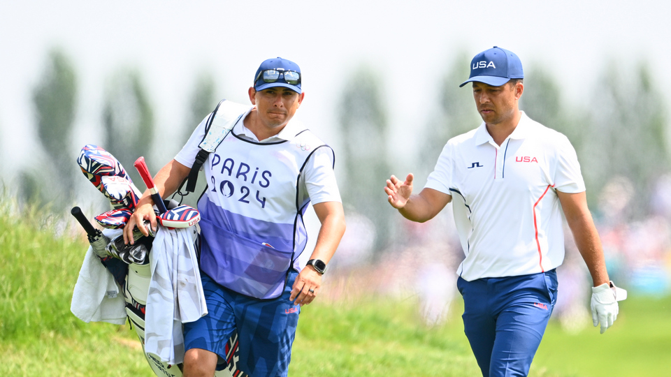 Xander Schauffele walks with his caddie, Austin Kaiser, on the 12th hole during the second round of the 2024 Paris Olympics at Le Golf National