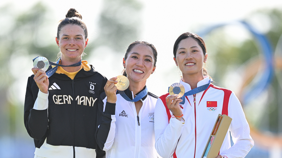 Lydia Ko of Team New Zealand, gold medalist, Esther Henseleit of Team Germany, silver medalist, and Xiyu Lin of team China, bronze medalist, stand together during the medal ceremony after the final round of the 2024 Paris Olympic Games at Le Golf National