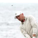 England’s Matt Wallace chips towards the green with the sea in the background