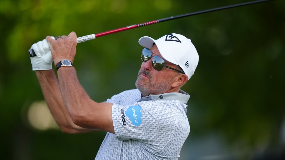 Phil Mickelson hits his tee shot on the 10th hole during the first round of the PGA Championship at Quail Hollow Club