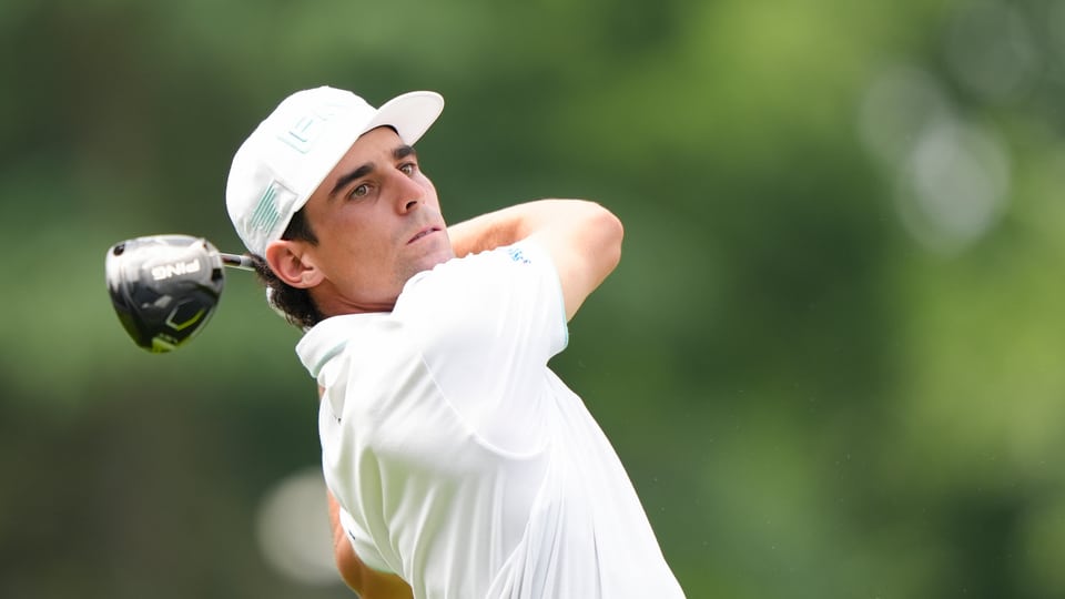 Joaquin Niemann hits his tee shot on the ninth hole during the second round