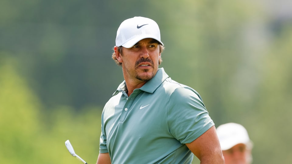 Brooks Koepka watches his tee shot on the fifth hole