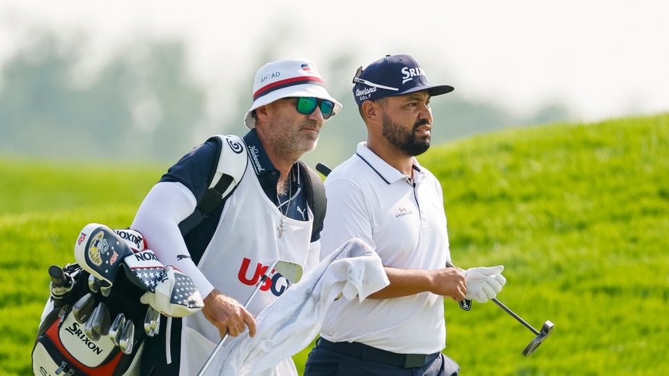 J.J. Spaun walks up to the 18th hole with caddie during the first round of the 2025 U.S. Open at Oakmont Country Club