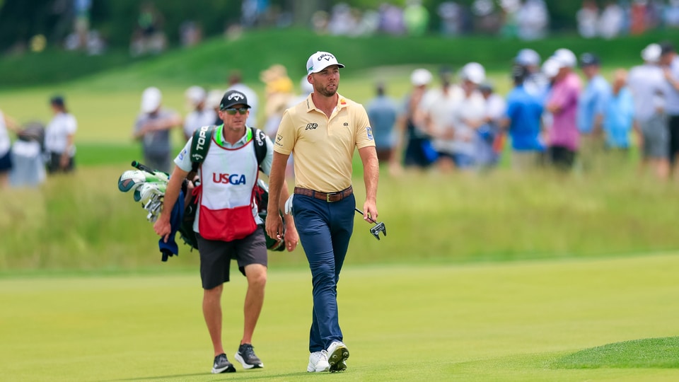 Sam Burns walks up the ninth fairway alongside his caddie Travis Perkins 