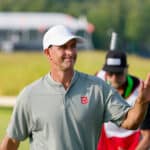Adam Scott waves to crowd after making a birdie shot on the 14th hole with caddie, Matthew Tritton, during the third round of the 2025 U.S. Open at Oakmont Country Club