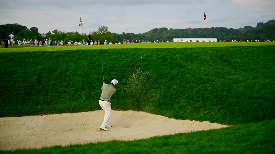 Adam Scott plays his shot out of a bunker on the 17th hole during the third round 