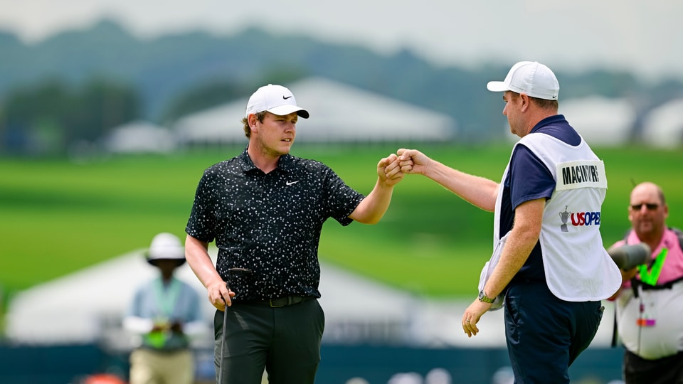Robert MacIntyre and his caddie, Michael Burrow, after he sinks his eagle putt on the fourth hole during the final round 