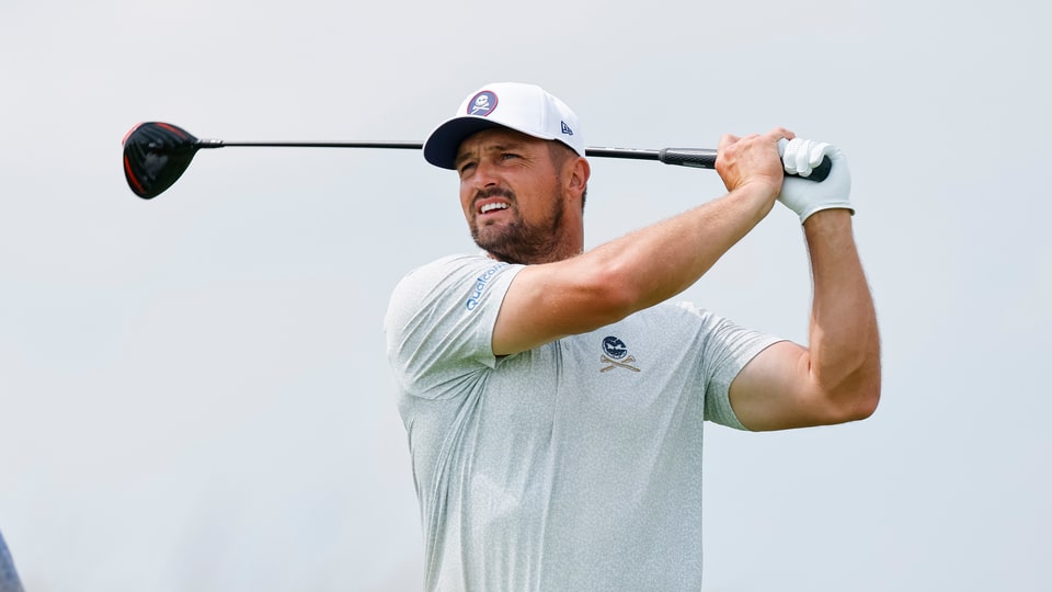 Bryson DeChambeau plays a shot on the 18th hole during a practice round