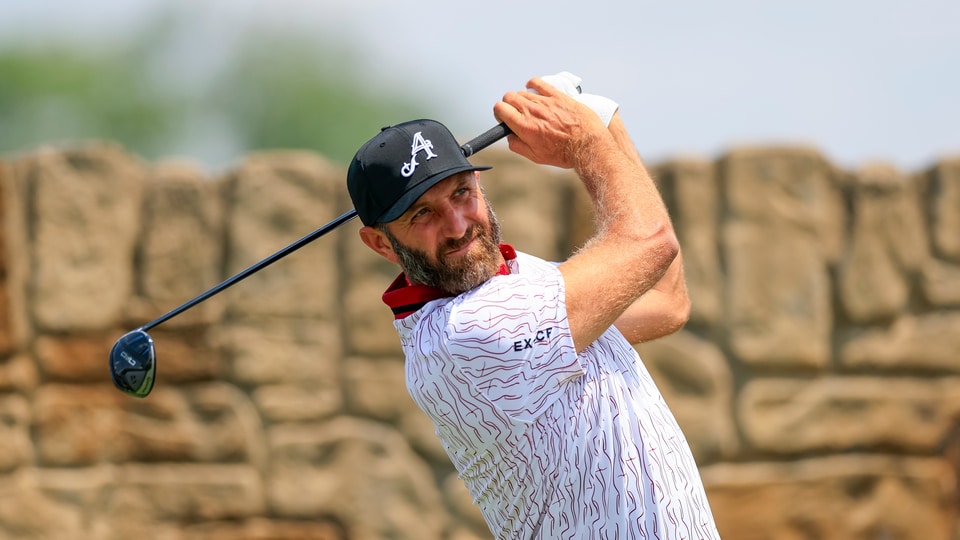 Dustin Johnson watches his tee shot on the 11th hole during a practice round 