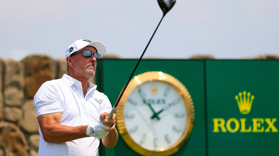 Phil Mickelson watches his tee shot on the 11th hole during a practice round 