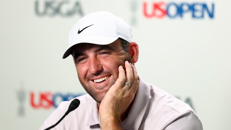 Scottie Scheffler talks to the press during a practice round